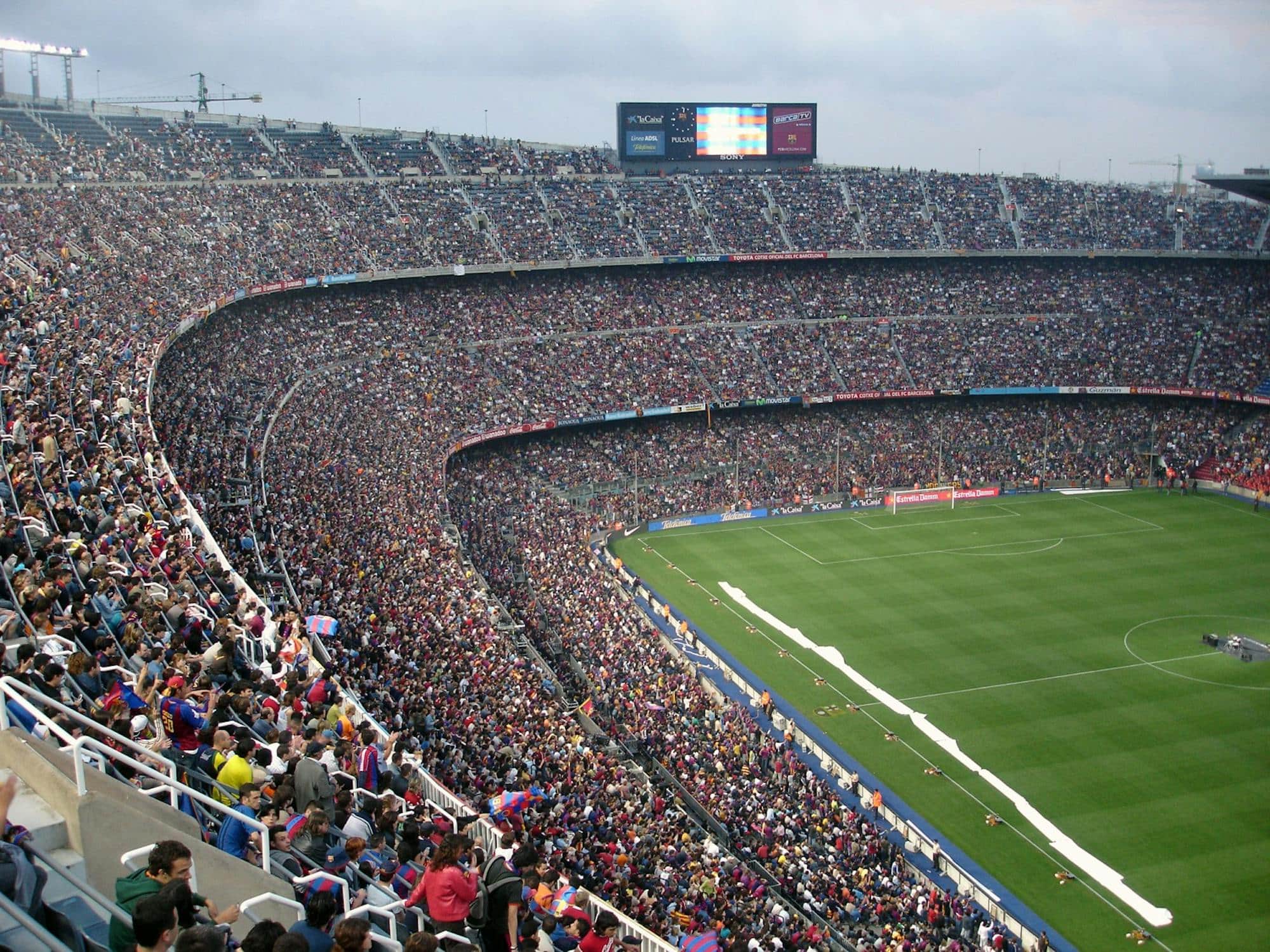 Wide view of a packed soccer stadium during a night match