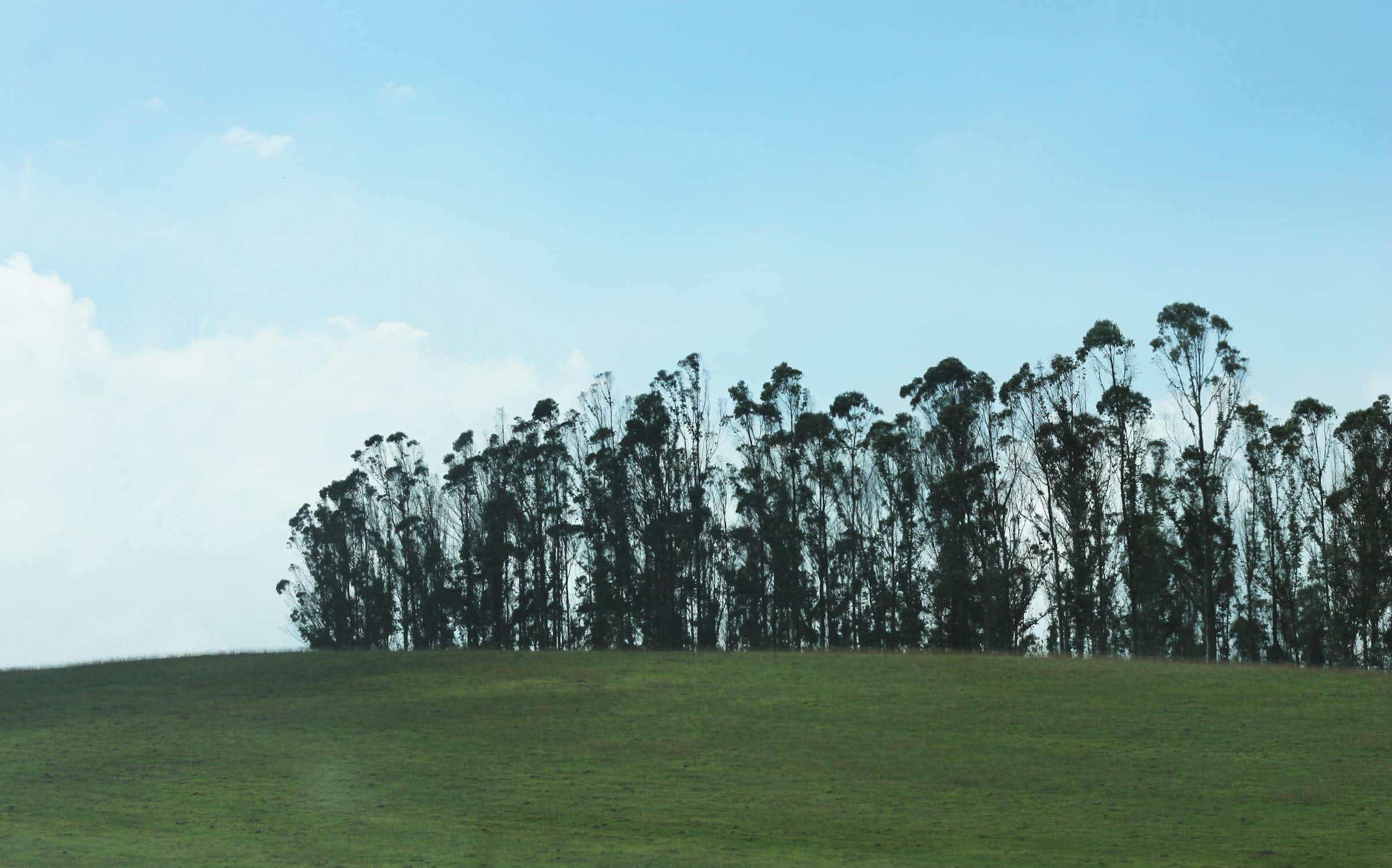 Modern sports stadium exterior at sunset with prominent corporate naming signage